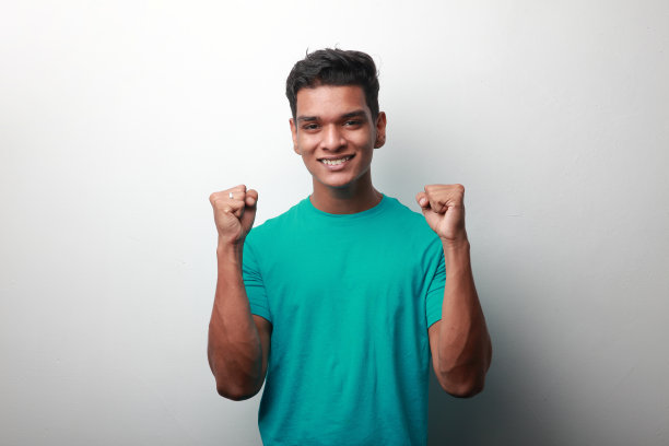 快乐的印度裔年轻人，带着欢呼的姿态图片下载