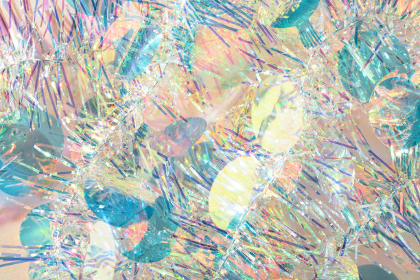 五彩缤纷的五彩纸屑圣诞金丝花环纹理抽象背景。图片下载