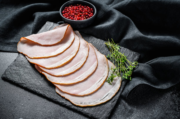 五香熏猪肉，美味火腿。黑色背景。俯视图图片下载