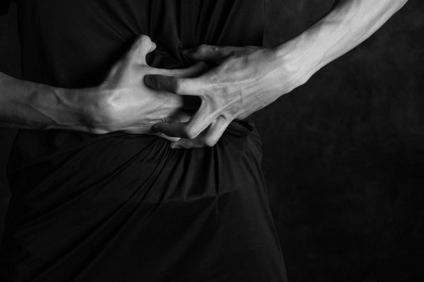 年轻人饱受胃痛的折磨，受伤、沮丧和极度沮丧。图片下载