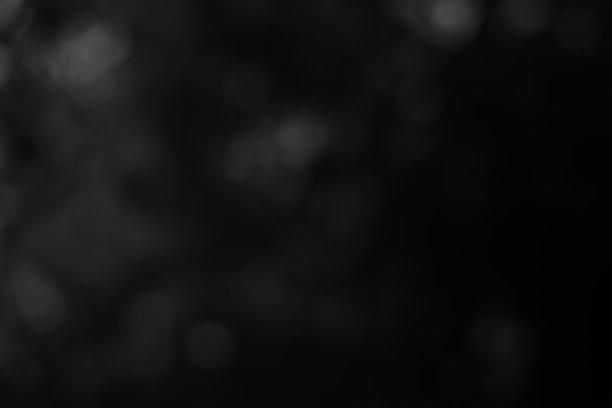黑暗模糊的圣诞灯光背景。设计效果聚焦快乐节日派对辉光纹理黑色壁纸散景太阳阳光星星闪亮柔软素色温暖闪耀模糊新年夜灯。图片下载