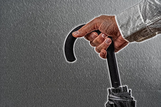 男子撑着合拢的伞图片下载