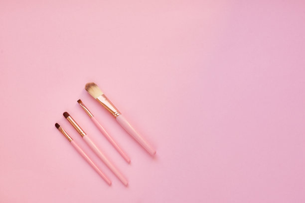 彩妆护肤的概念，彩妆刷上粉色的背景。图片下载