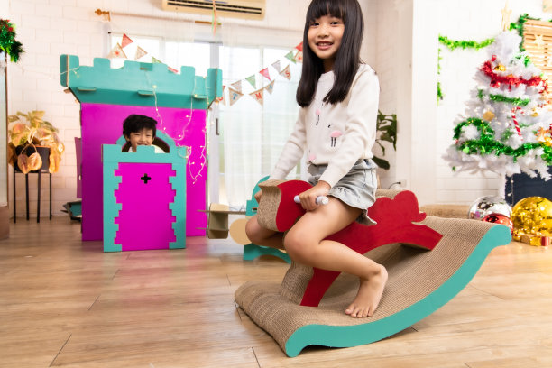 可爱的孩子们玩而父母在家里一起放松，微笑活跃的男孩娱乐纸玩具，摇摆马，幸福的家庭一起在客厅度过周末时间。亚洲家庭幸福时光的概念。图片下载