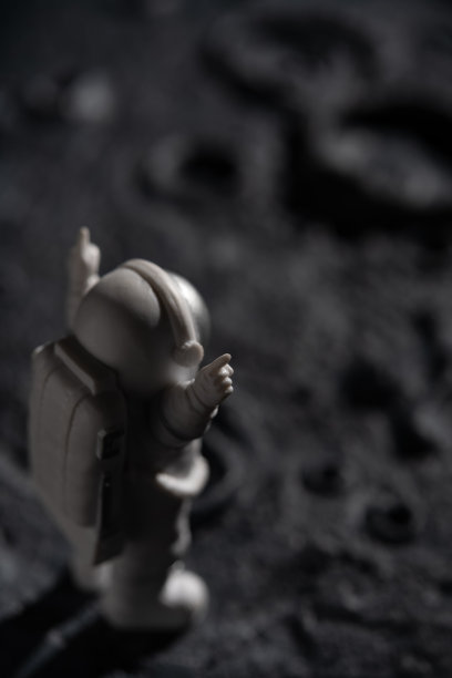 宇航员站在一个布满陨石坑的星球上图片下载