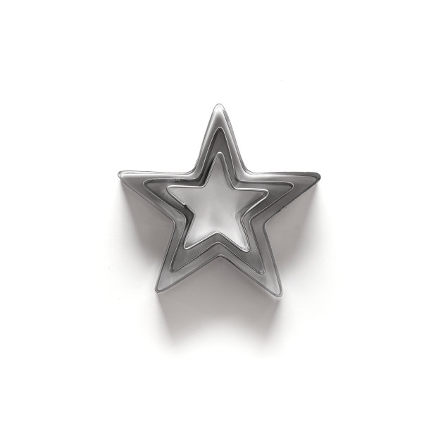 圣诞主题的姜饼切割机，白色的星星形状。图片下载