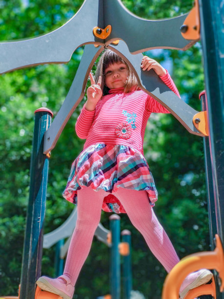 在一个阳光明媚的日子里，女孩在操场上玩耍图片下载