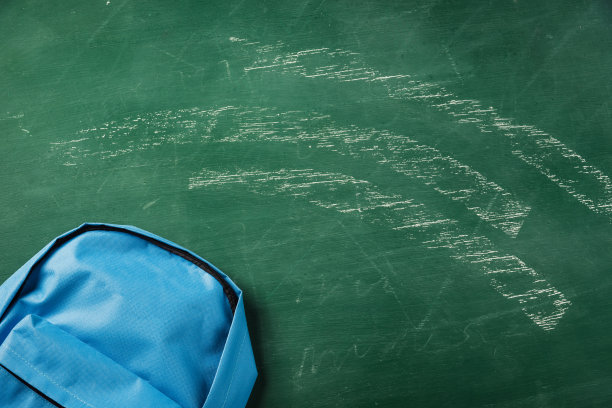 书包放在绿色的黑板上图片下载