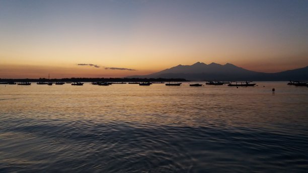 海滩山和渔船在日出图片下载