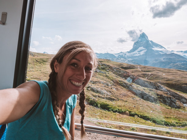 快乐的女人在瑞士策马特的火车上自拍图片下载