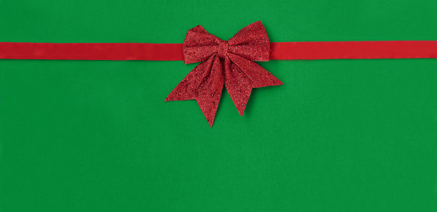 红色蝴蝶结在绿色背景股票照片图片下载