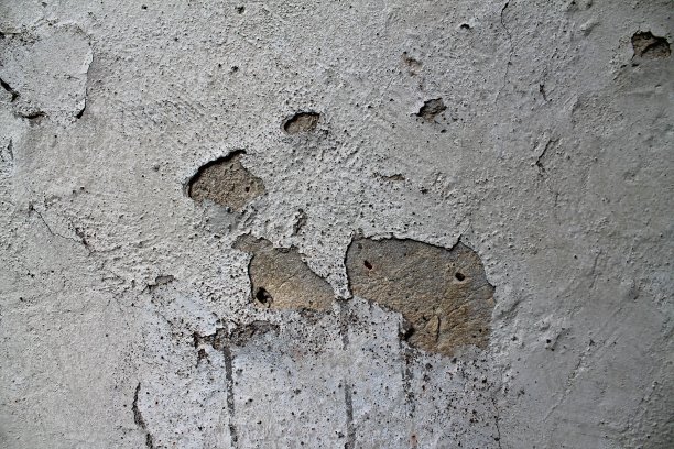 详细的近距离观察老化的混凝土墙裂缝和许多结构图片下载