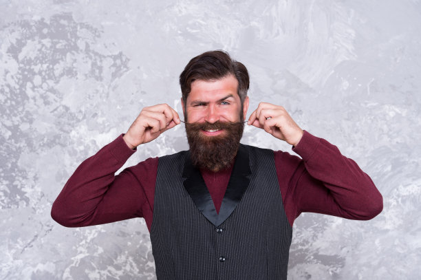 梳得整齐的潮人。理发店的概念。美容行业。面部毛发护理。蓄着长胡子的成熟男人。样式的胡子。日益增长的长胡子。小胡子的风格图片下载