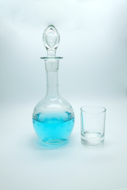 瓶中的蓝色酒精饮料。鸡尾酒蓝色杜松子酒，奎宁水图片下载