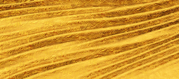金色的丝绸布料，波浪般的金色丝绸为背景图片下载