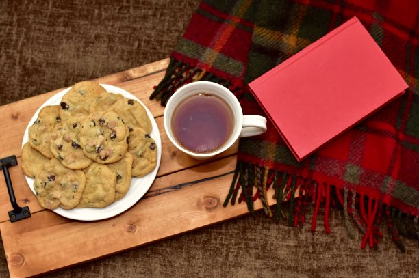 新鲜温暖的自制巧克力饼干，喝一杯热茶，放松在寒冷的冬天下午与一本书图片下载