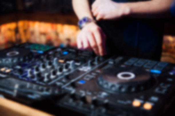 抽象模糊DJ手的遥控器。夜店，夜生活的概念图片下载