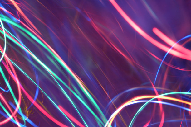 摘要多色光运动的波浪形和圆形的线轨迹背景。发光和明亮的霓虹灯颜色。图片下载