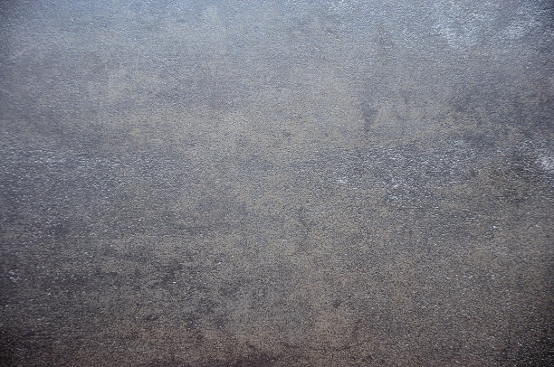 一种黑色天然石材的平整、粗糙的表面。图片下载