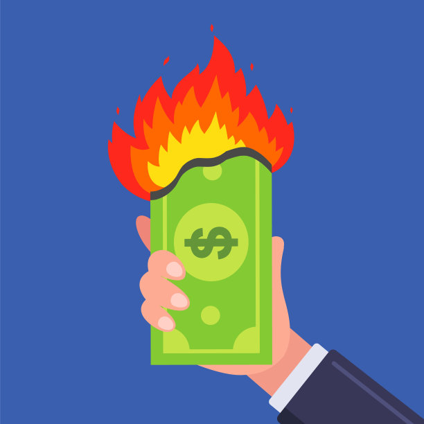 一张钞票在一个人的手里燃烧着。商业金融危机图片下载