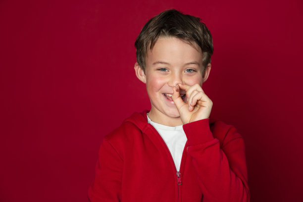 很酷的小男孩用红色的铅笔在红色的背景图片下载