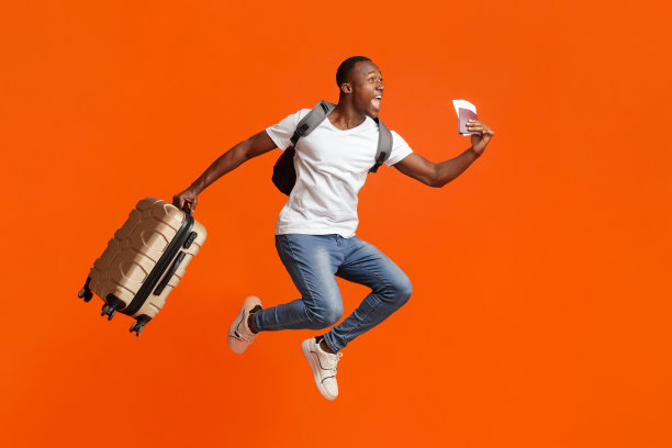 一个带着护照和行李箱的快乐黑人跳了起来图片下载