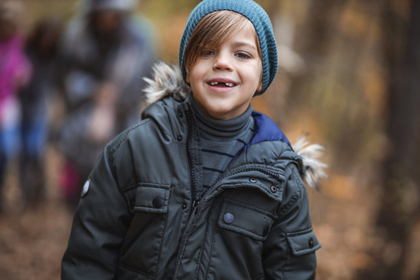 可爱的小男孩在森林里，秋天的时候图片下载