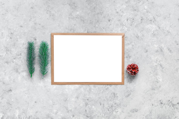 空白的白色卡片模型，工艺信封，杉木树枝。灰色混凝土垃圾背景。圣诞模板为您的设计。俯视图，平放，复制空间。图片下载