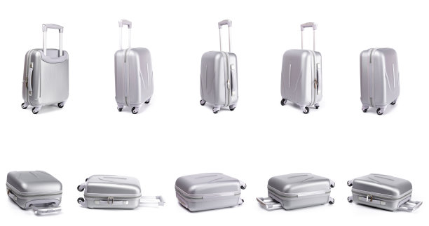 手提箱孤立在白色上。一套银色旅行袋或塑料行李上的白色背景。暑假与产品广告概念。图片下载