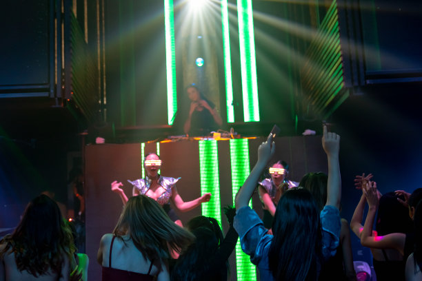 一群人在迪斯科夜总会随着DJ的音乐节奏跳舞图片下载