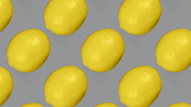 灰色背景上的两个柠檬。图片下载