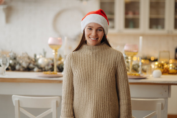 漂亮的年轻女子看着家里的摄像机。图片下载