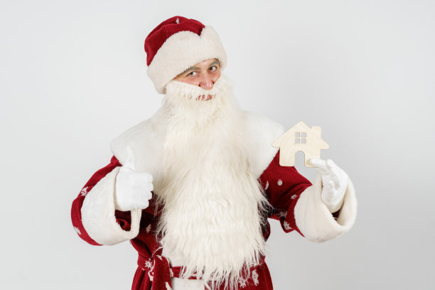 房子是圣诞老人的礼物。在光背景上隔离图片下载