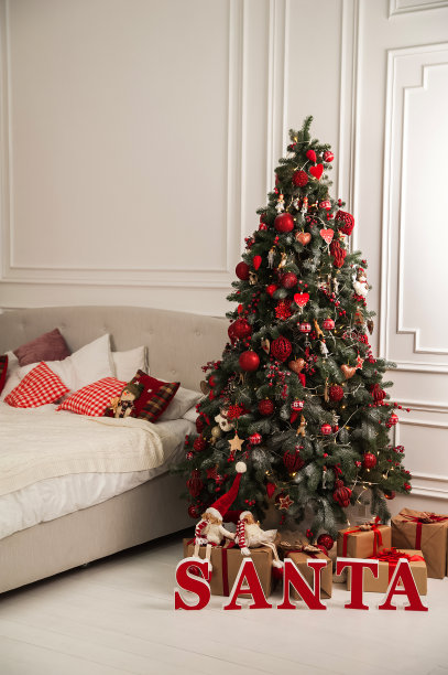 新年卧室的装饰采用斯堪的纳维亚风格。圣诞树、圣诞老人和有枕头的床。Hygge新年概念。图片下载