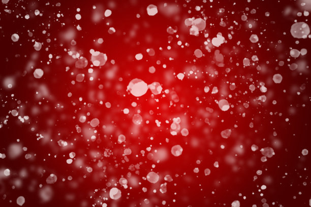 失去焦点的白色雪花散落在红色的背景上图片下载