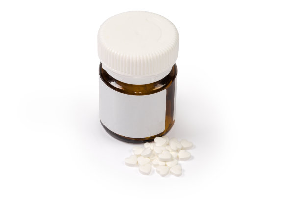 一堆白色心形药丸和玻璃容器图片下载