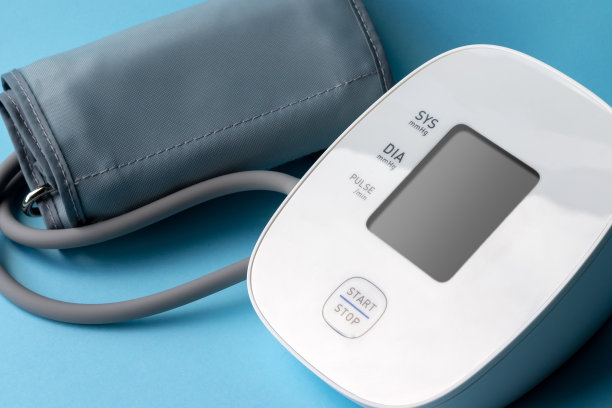 蓝色背景上的自动血压监测仪。医疗电子血压计。特写视图图片下载