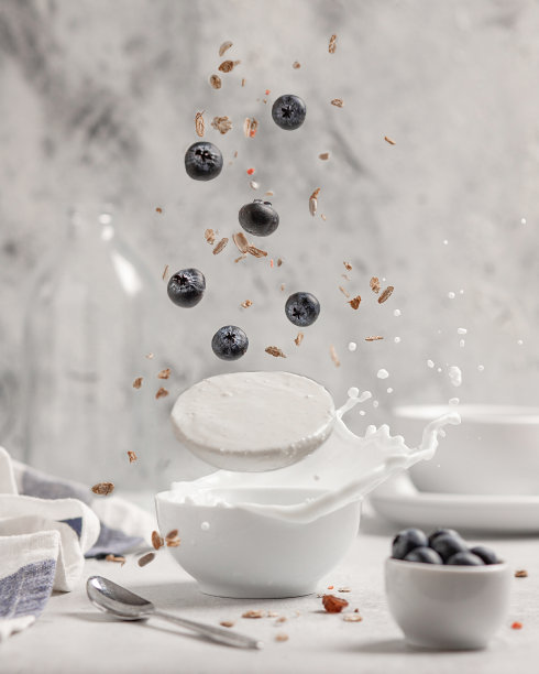 酸奶与蓝莓和什锦麦片在一个较轻的背景。飞行产品的概念，悬浮。图片下载
