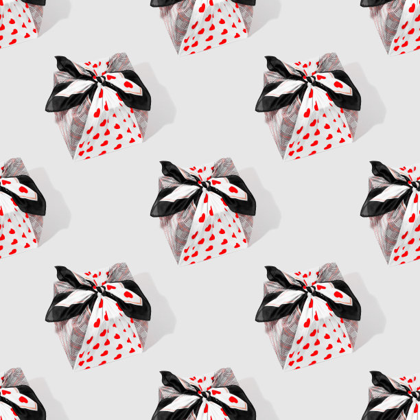 灰色背景上的织物包裹礼物的摄影图案图片下载