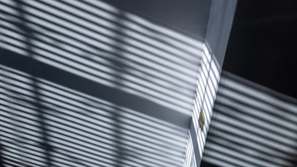 影子楼。抽象的光线，黑色的阴影从窗户覆盖在白色纹理的墙壁上。阳光建筑背景。叠加效果的照片和设计。图片下载