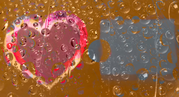 多色的水滴位于一个棕色的背景和一个黄红酒红色的心剪影和一个碑文的地方。图片下载