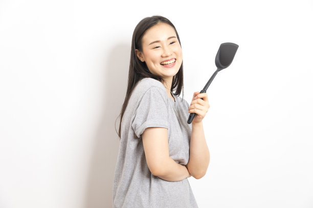 白底黑勺的亚洲家庭主妇。图片下载