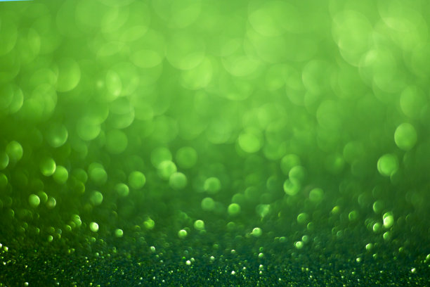 绿色模糊的背景有光泽的散景。图片下载