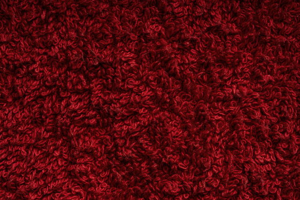 红色毛巾纹理为背景。由棉纤维材料制成的织物或纺织品。图片下载