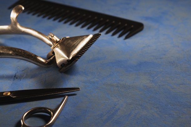 蓝色的表面上是老式的理发工具。蓝色背景。水平图片下载