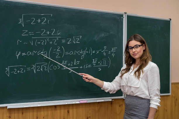 性感的白人女老师在课堂上用数学公式对着黑板图片下载