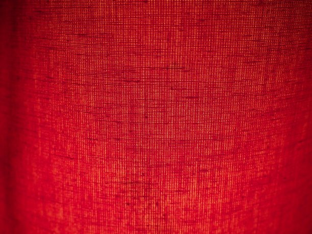 红色抽象背景织物。宏观的形象。用黑影和小图案编织出丝锥色的坑。圣诞节，新年，情人节的背景。图片下载