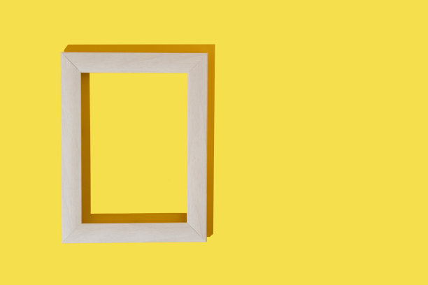 灰色框架的照片或绘画在明亮的黄色背景。模型。插入文本、图像的地方。前视图。平的。图片下载