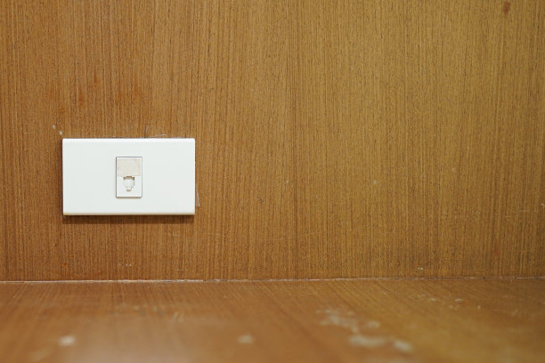 旧的白色电源插头附在木墙上。图片下载