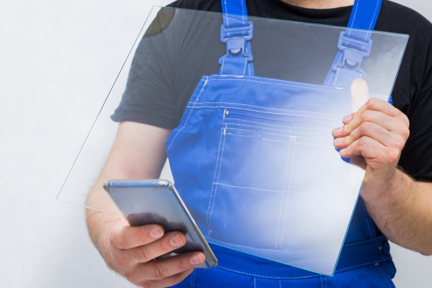 工人拿着玻璃看手机，工作安全理念图片下载